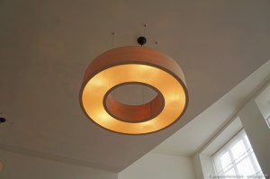 Big round pendant lamp in the shape of a donut, made of maple wood veneer of with several E27 light sockets inside